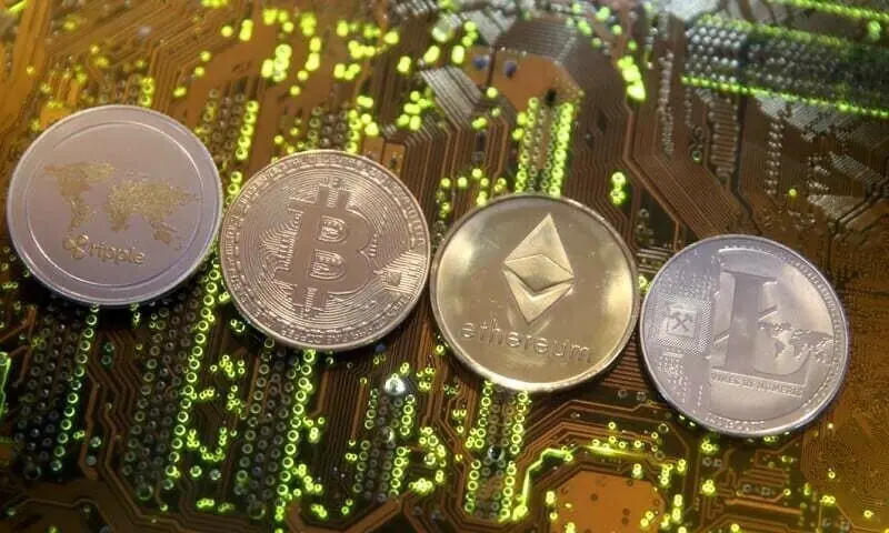 Representations of the Ripple, Bitcoin, Etherum and Litecoin virtual currencies are seen on a PC motherboard in this illustration picture. &mdash; Reuters/File