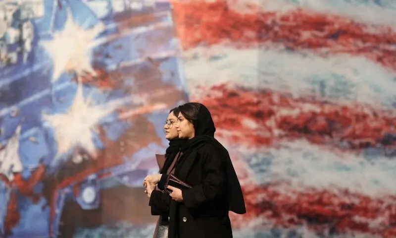 People walk past an anti-U.S. billboard in Tehran, Iran, January 26, 2026.  &mdash;Reuters