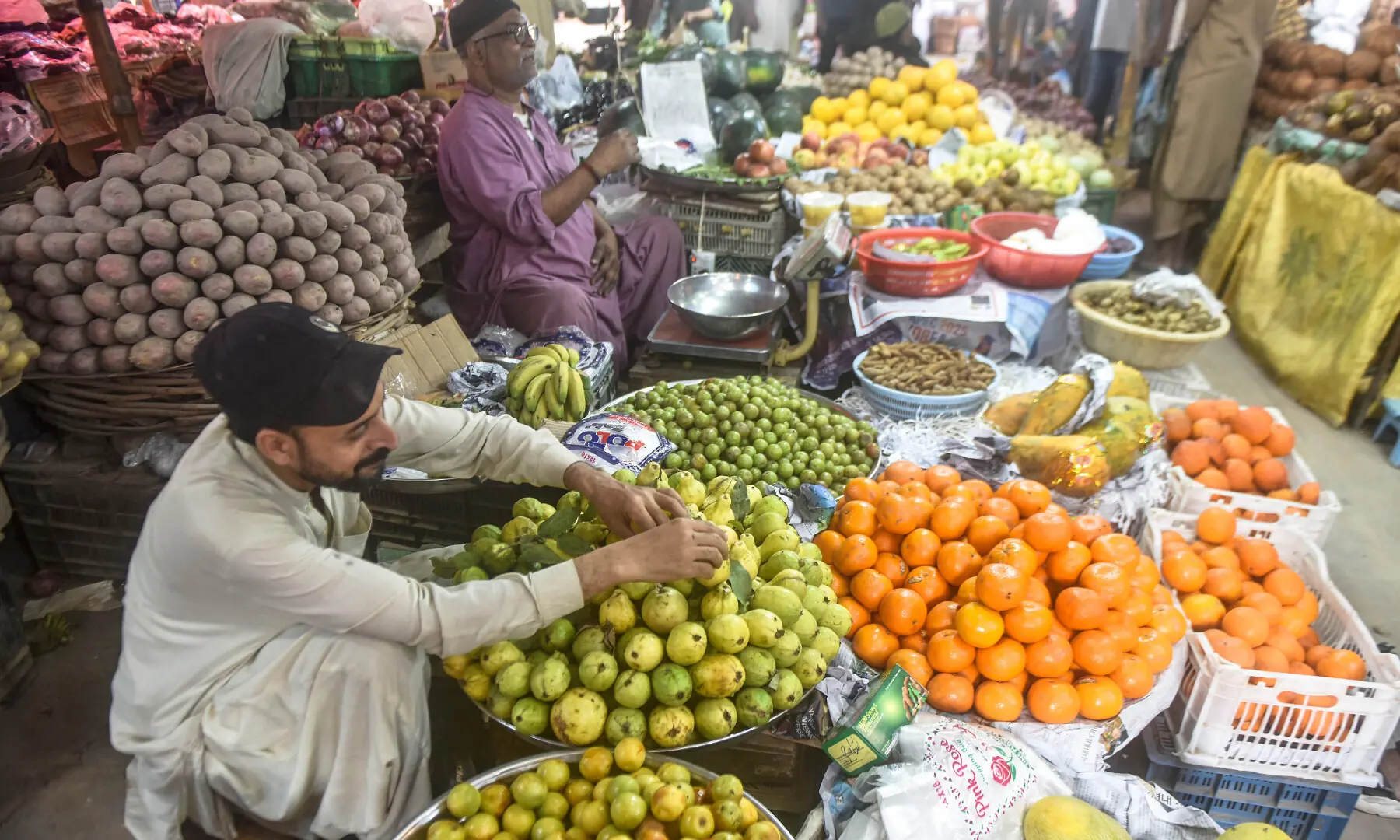 A vendor arranges fruits to attract customers in Karachi.  &mdash; Fahim Siddiqui / White Star