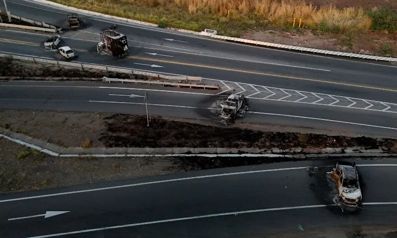 This aerial view shows burned cars and trucks, allegedly set on fire by organised crime groups in response to an operation to arrest a high-priority security target, on a highway near Acatlan de Juarez, Jalisco state, Mexico on February 22, 2026. &mdash;AFP