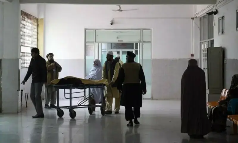 In this file photo,  relatives tend to a man treated at a hospital in Peshawar. &mdash; AFP/File