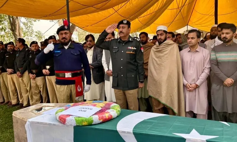 Police personnel offer a guard of honour to martyrs at a funeral in Bannu, Thursday, Feb 26. &mdash; Photo via author