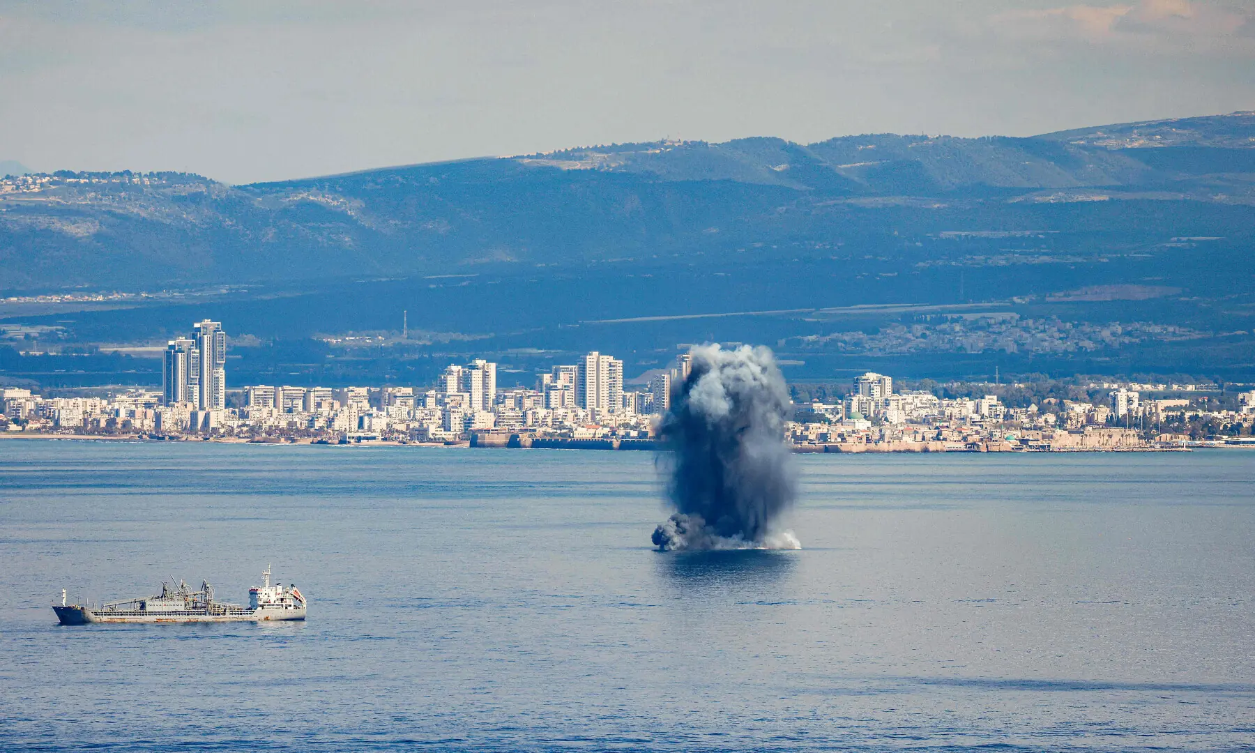 An incoming projectile explodes over the water in the bay of Haifa off of the northern Israeli coastal city on February 28, 2026. &mdash; AFP