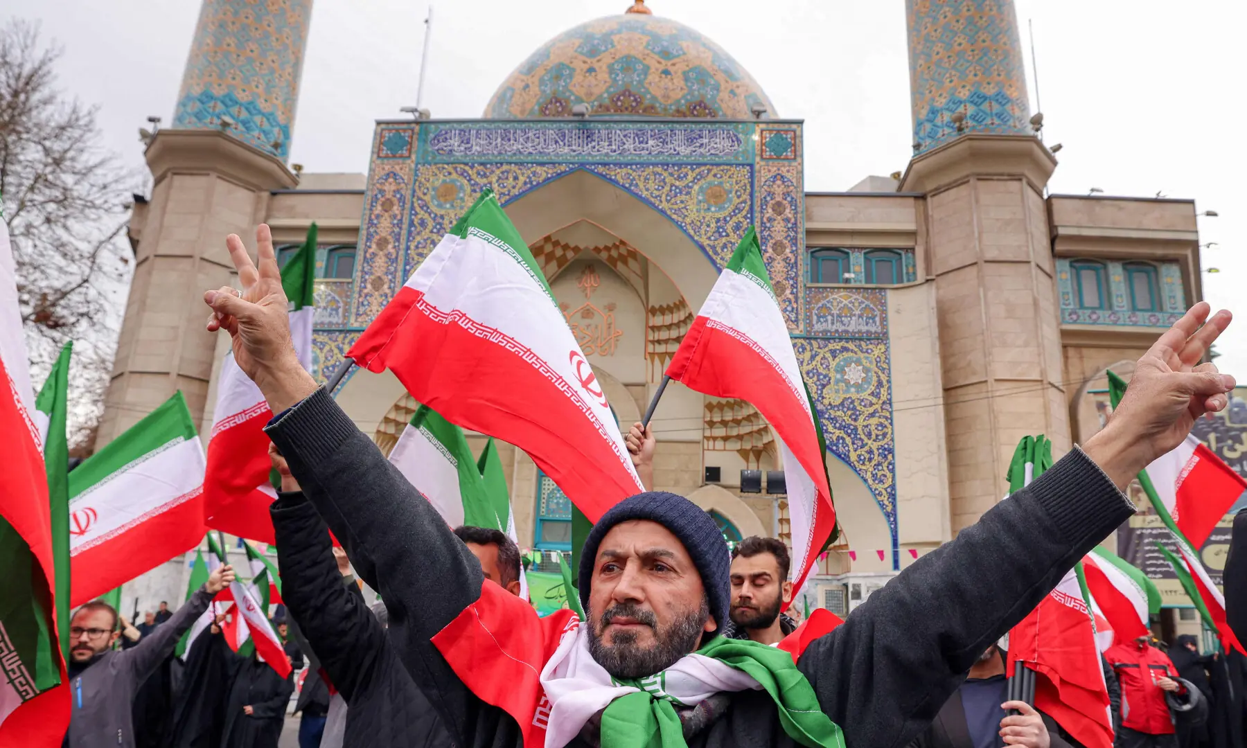  Protesters gather with Iranian national flags during a demonstration in support of the government and against US and Israeli strikes outside a mosque in Tehran on February 28, 2026. &mdash; AFP 