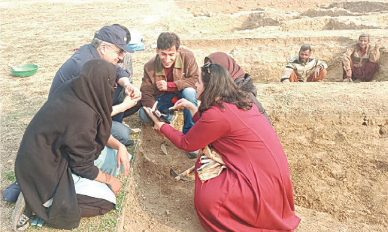 Unesco Director General Dr Khaled El-Enany briefs young archaeologists on excavation techniques at the Bhir Mound archaeological site during his visit to the Taxila Museum on Sunday. &mdash; Dawn