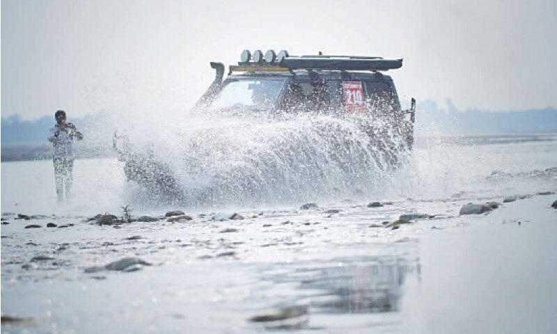 A driver crosses the Indus River during a race in Swabi on Sunday. &mdash; Photo by Muqaddam Khan