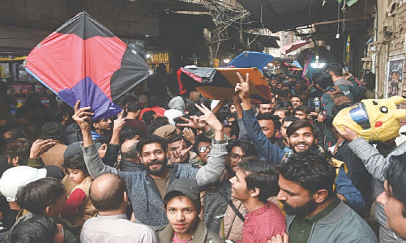 YOUNGSTERS throng the narrow alleys of Lahore&rsquo;s Mochi Gate as they procure kites ahead of the upcoming festival.&mdash;Murtaza Ali