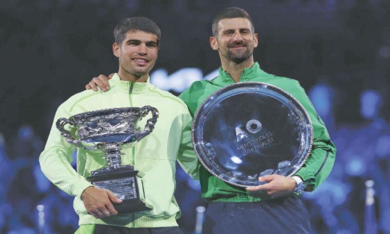 SPAIN&rsquo;S Carlos Alcaraz (L) and runner-up Novak Djokovic of Serbia pose with their Australian Open titles at the Melbourne Park on Sunday.&mdash;AFP