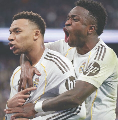 MADRID: Real Madrid&rsquo;s Kylian Mbappe (L) celebrates scoring with Vinicius Jr during their La Liga match against Rayo Vallecano at Santiago Bernabeu on Sunday.&mdash;Reuters