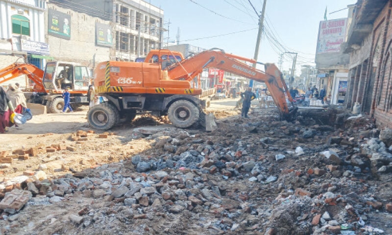 GUJRAT: Thana Road in Dinga town is being cleared of illegal structures. — Dawn GUJRAT: Thana Road in Dinga town is being cleared of illegal structures. — Dawn