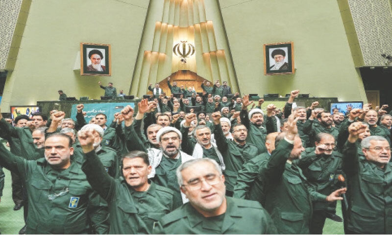 Legislators wearing military uniform raise slogans in support of IRGC.&mdash;Reuters