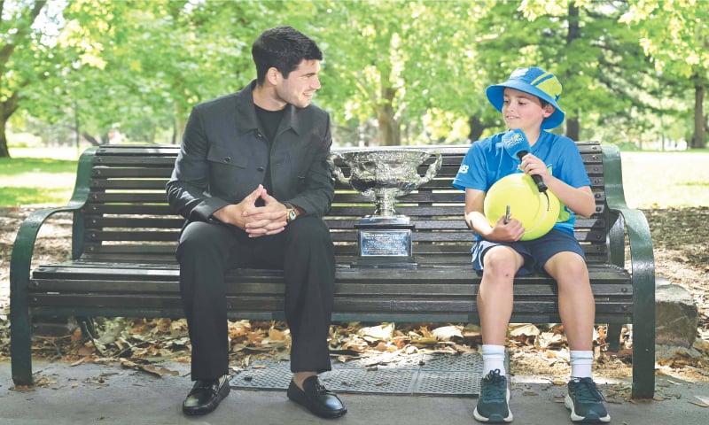 MELBOURNE: Spain’s Carlos Alcaraz is interviewed by a child after posing with the Norman Brookes Challenge Cup at the Royal Exhibition Building following his victory against Serbia’s Novak Djokovic in the Australian Open final on Monday.—AFP MELBOURNE: Spain’s Carlos Alcaraz is interviewed by a child after posing with the Norman Brookes Challenge Cup at the Royal Exhibition Building following his victory against Serbia’s Novak Djokovic in the Australian Open final on Monday.—AFP