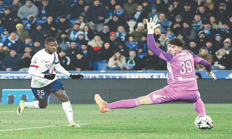 STRASBOURG: Paris St Germain’s Nuno Mendes scores past Strasbourg goalkeeper Mike Penders during their Ligue 1 match at Stade de la Meinau.—Reuters STRASBOURG: Paris St Germain’s Nuno Mendes scores past Strasbourg goalkeeper Mike Penders during their Ligue 1 match at Stade de la Meinau.—Reuters