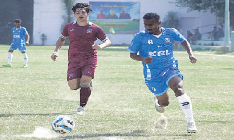 KARACHI: Players in action during the National Challenge Cup match between Khan Research Laboratories and Wapda at the KMC Stadium on Wednesday.&mdash;Courtesy PFF