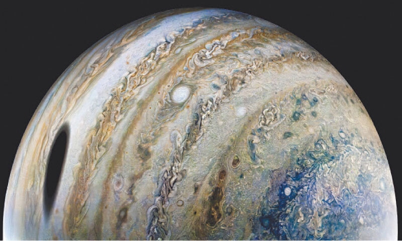 AN enhanced colour image of Jupiter, with a shadow of its moon Ganymede on the left.—Reuters AN enhanced colour image of Jupiter, with a shadow of its moon Ganymede on the left.—Reuters