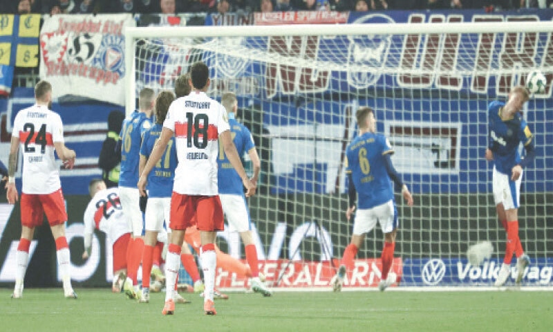 KIEL: VfB Stuttgart’s Deniz Undav (second L) scores during the German Cup quarter-final against Holstein Kiel at Holstein-Stadionon.—AFP KIEL: VfB Stuttgart’s Deniz Undav (second L) scores during the German Cup quarter-final against Holstein Kiel at Holstein-Stadionon.—AFP