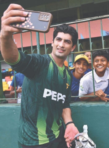 PAKISTAN pacer Naseem Shah takes selfies with young fans.&mdash;AFP