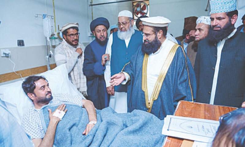 CLERICS, led by Allama Hafiz Tahir Ashrafi, visit a man injured in the Imambargah attack, at Pims on Saturday.&mdash;Photo by the writer