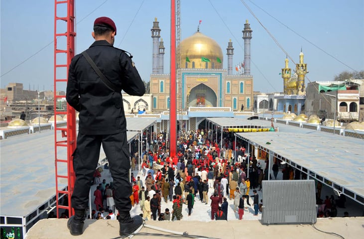 A POLICEMAN stands guard to provide security cover on the first day of Hazrat Lal Shahbaz Urs celebrations.—Umair Ali