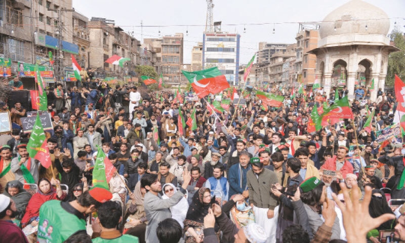 PESHAWAR: PTI workers wave party flags as they gather at Chowk Yadgar for a protest demonstration on the second anniversary of the February 8, 2024 elections.&mdash;Shahbaz Butt/White Star