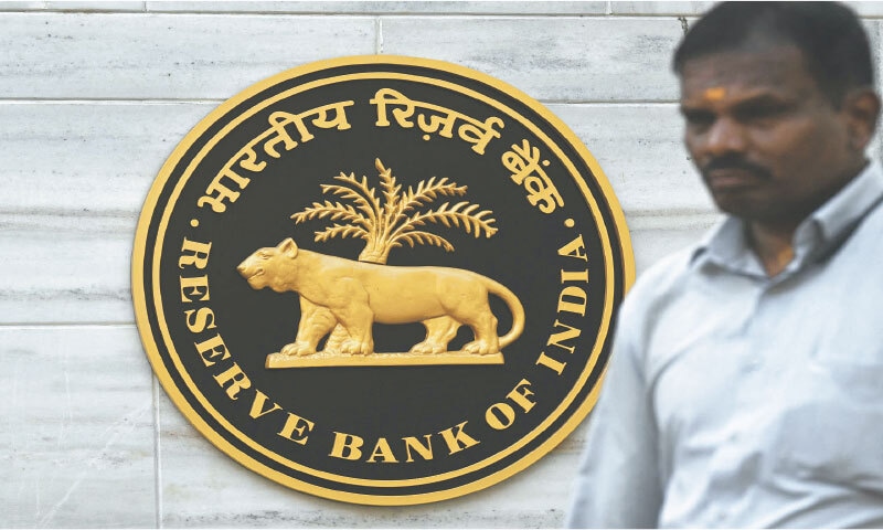 A pedestrian walks past the Reserve Bank of India (RBI) headquarters in Mumbai last week. The RBI Monetary Policy Committee announced unanimously that the central bank&rsquo;s repo rate remains unchanged at 5.25 per cent.&mdash;AFP