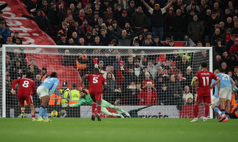 LIVERPOOL: Manchester City&rsquo;s Erling Haaland (R, obscure) scores from the penalty spot against Liverpool during their Premier League match at Anfield on Sunday.&mdash;Reuters