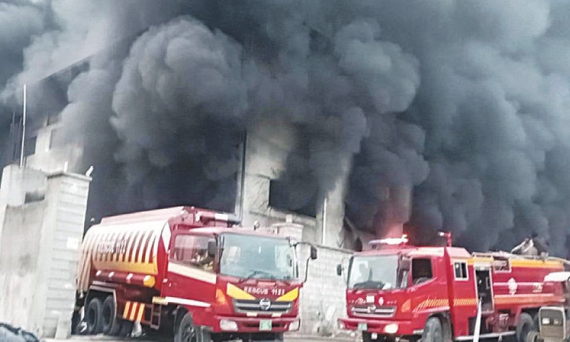 Thick clouds of smoke rise from a textile factory in the Rawat Industrial Estate on Monday. &mdash; White Star