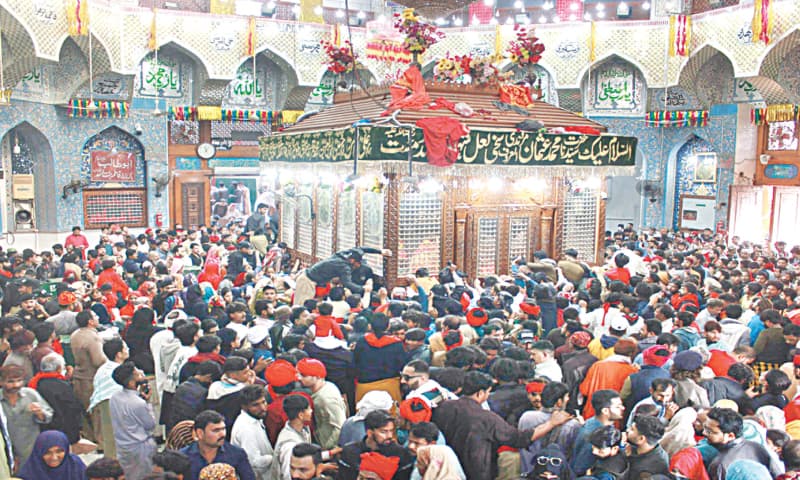A CROWD of devotees gathers around the grave of Lal Shahbaz Qalandar to pay their respects on the last day of the Urs.&mdash;Dawn