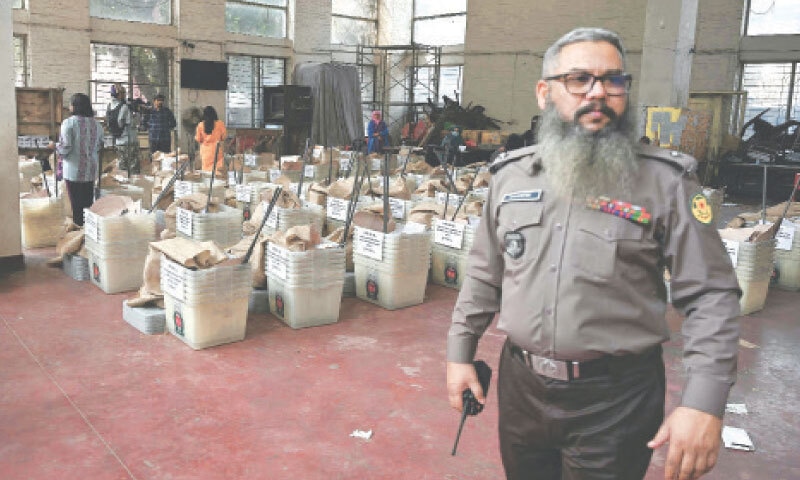 A POLICEMAN guards ballot boxes before they are dispatched to polling stations in Dhaka.&mdash;AFP