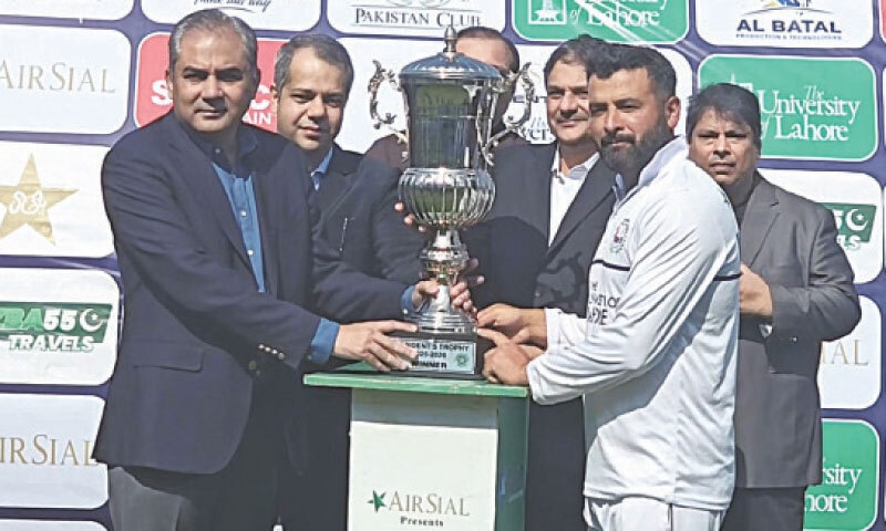 PAKISTAN Cricket Board chairman Mohsin Naqvi (L) presents the President&rsquo;s Trophy to Wapda captain Khalid Usman at the Gaddafi Stadium on Wednesday.&mdash;Courtesy PCB