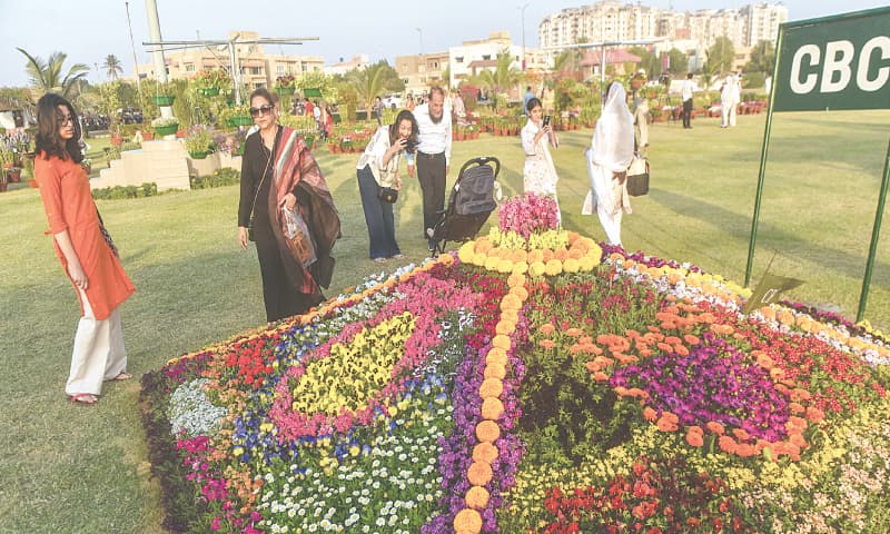 Visitors enjoy the charming ambience of the flower show at A.K. Khan Park near Seaview.&mdash;Fahim Siddiqi/ White Star