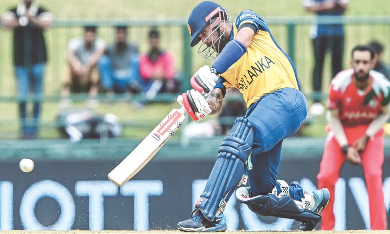 PALLEKELE: Sri Lankan batter Kusal Mendis plays a shot during the group stage match against Oman at the Pallekele International Stadium on Thursday.—AFP PALLEKELE: Sri Lankan batter Kusal Mendis plays a shot during the group stage match against Oman at the Pallekele International Stadium on Thursday.—AFP