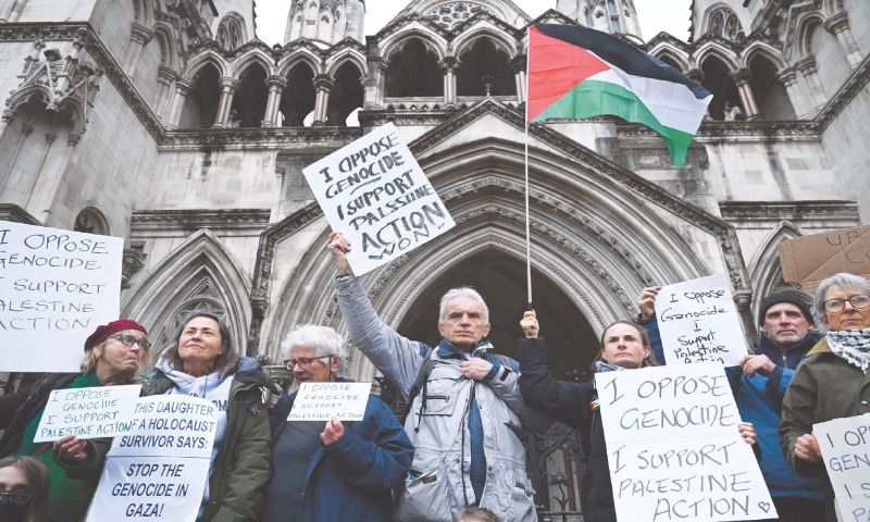 Protesters holding placards demonstrate outside London’s Royal Courts of Justice, after judges ruled the government’s decision to designate Palestine Action as a terrorist organisation ‘unlawful’.—Reuters Protesters holding placards demonstrate outside London’s Royal Courts of Justice, after judges ruled the government’s decision to designate Palestine Action as a terrorist organisation ‘unlawful’.—Reuters