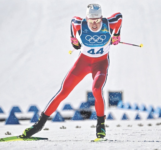 TESERO: Norway’s Johannes Hoesflot Klaebo sprints to the finish line during the 10km cross-country interval start free event of the Winter Olympics at the Tesero Cross-Country Skiing Stadium on Friday.—AFP
