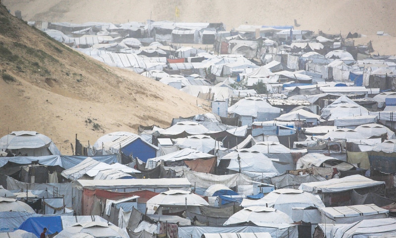 KHAN YUNIS: Tents and makeshift shelters at a camp for displaced people. Palestinians face shortages of essential items as access points to Gaza remain under Israeli control.—AFP KHAN YUNIS: Tents and makeshift shelters at a camp for displaced people. Palestinians face shortages of essential items as access points to Gaza remain under Israeli control.—AFP
