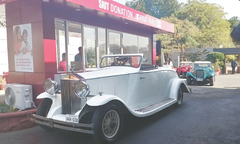 Vintage and classic cars at the 24-hour SIUT donation drive-thru.
&mdash;Photo by the writer