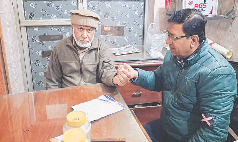 HAKEEM Ishaq Sultan examines a patient at his clinic in Lahore.—Photo by the writer HAKEEM Ishaq Sultan examines a patient at his clinic in Lahore.—Photo by the writer