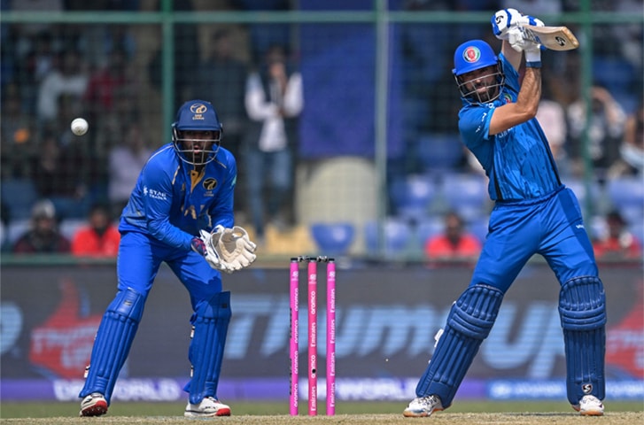 NEW DELHI: Afghanistan opener Ibrahim Zadran plays a shot as UAE wicket-keeper Aryansh Sharma looks on during their group stage match at the Arun Jaitley Stadium on Monday.&mdash;AFP