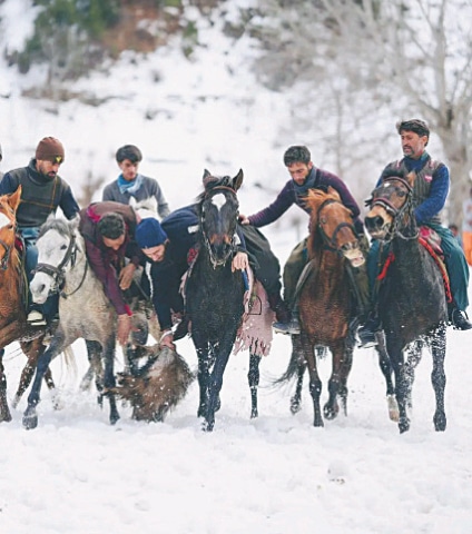 Players fight for the goat carcass during a buzkashi match on the second day of Kalash indigenous winter sports festival in Bumbruat Valley, Lower Chitral. — Photo by Zahiruddin