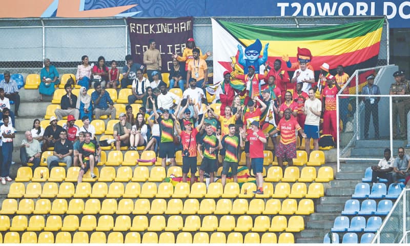 PALLEKELE: Fans of team Zimbabwe cheer as the group stage match between Zimbabwe and Ireland was called off due to rain at the Pallekele International Cricket Stadium on Tuesday.—AFP PALLEKELE: Fans of team Zimbabwe cheer as the group stage match between Zimbabwe and Ireland was called off due to rain at the Pallekele International Cricket Stadium on Tuesday.—AFP