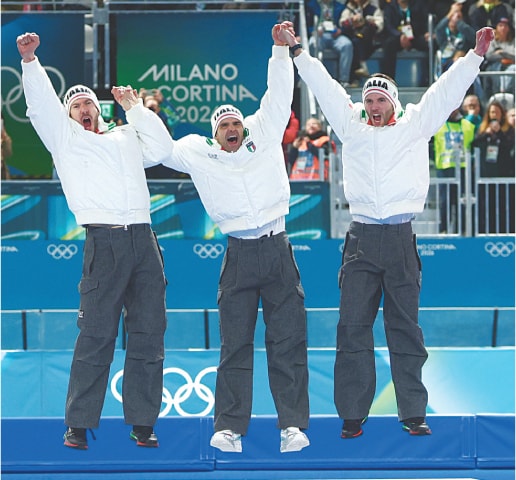 MILAN: (from L) Italy&rsquo;s gold medallists Davide Ghiotto, Michele Malfatti and Andrea Giovannini celebrate on the podium after winning the speed skating men&rsquo;s team pursuit competition during the Winter Olympics on Tuesday.&mdash;Reuters