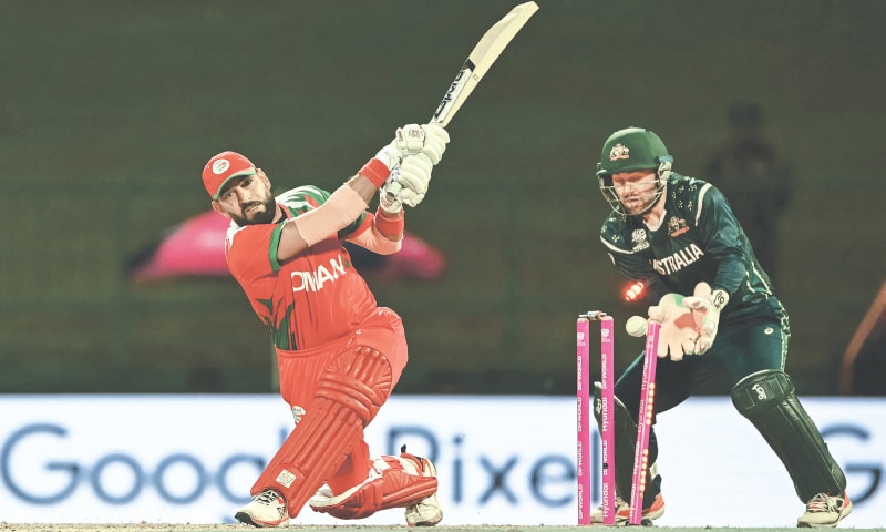 PALLEKELE: Oman tailender Shafiq Jan is clean bowled by Australian leg-spinner Adam Zampa as wicket-keeper Josh Inglis reacts during their group stage match at the Pallekele International Cricket Stadium on Friday.&mdash;AFP