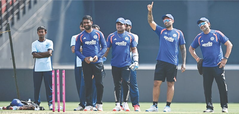  AHMEDABAD: Indian captain Suryakumar Yadav (second R), batting coach Sitanshu Kotak (R) and other players attend a practice session on Saturday.&mdash;AFP 