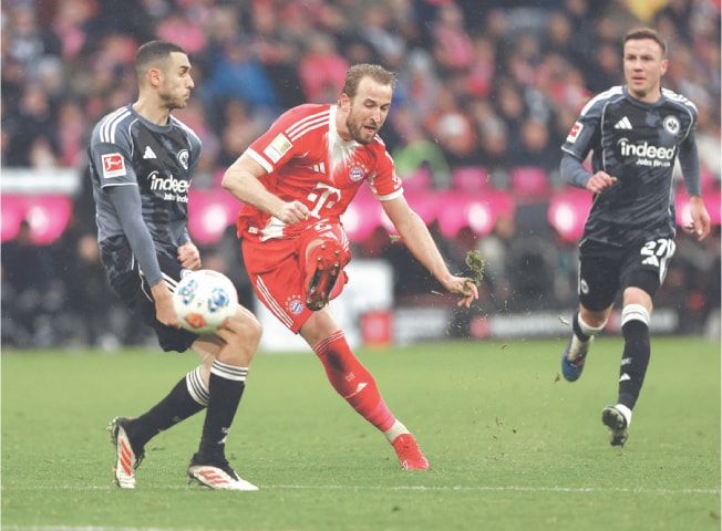 MUNICH: Bayern Munich’s Harry Kane (C) scores against Eintracht Frankfurt during their Bundesliga match at the Allianz Arena on Saturday.—Reuters