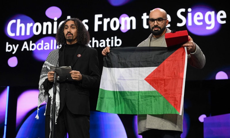 Palestinian director Abdallah Alkhatib (left) and Algerian producer Taqiyeddine Issaad accept the Best Feature Film Debut Award for Chronicles From the Siege during the 76th Berlinale.—AFP Palestinian director Abdallah Alkhatib (left) and Algerian producer Taqiyeddine Issaad accept the Best Feature Film Debut Award for Chronicles From the Siege during the 76th Berlinale.—AFP