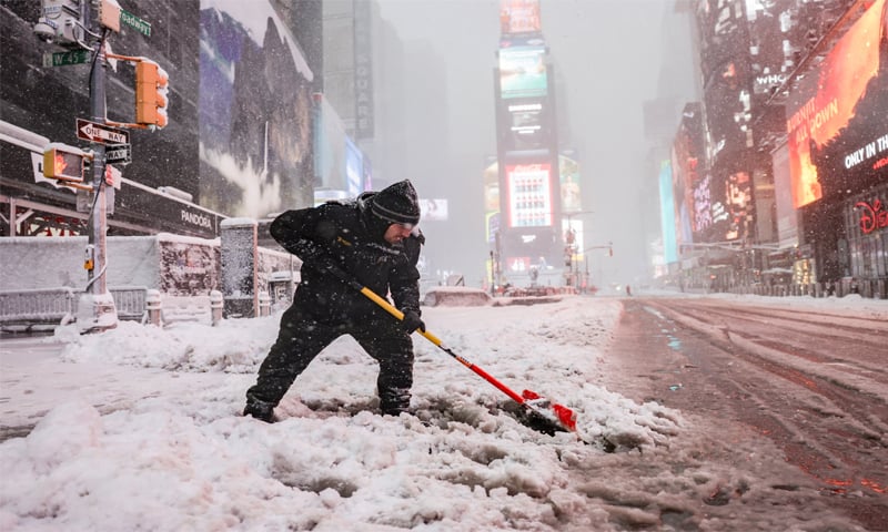 A worker clears snow on a street in New York City’s Times Square.—Reuters A worker clears snow on a street in New York City’s Times Square.—Reuters