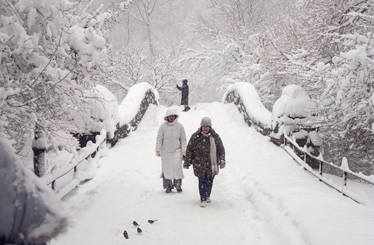 NEW YORK: People walk through several inches of snow in Central Park, as blizzard warnings were issued for large parts of the US East Coast.—AFP