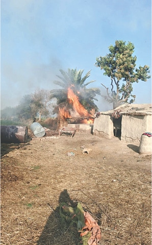 AN alleged hideout of dacoits torched by police in Khairpur.—Dawn