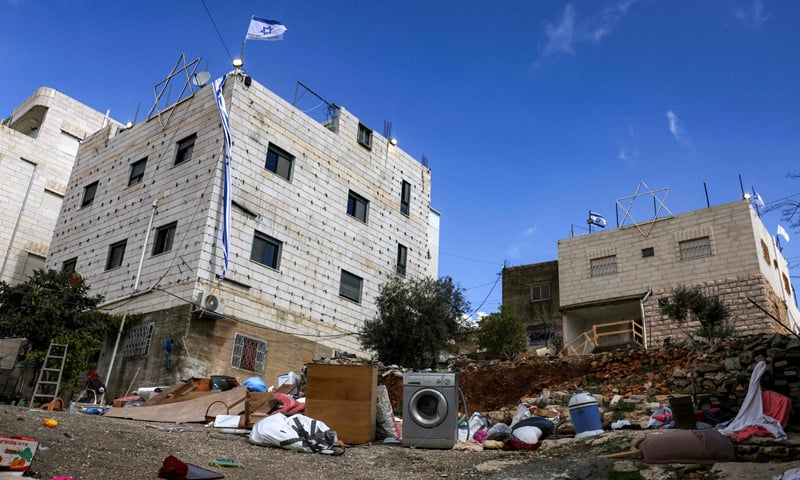Israel’s national flag flies over two Palestinian buildings, which were forcibly confiscated by the Israeli military in Hebron, occupied West Bank.—AFP Israel’s national flag flies over two Palestinian buildings, which were forcibly confiscated by the Israeli military in Hebron, occupied West Bank.—AFP