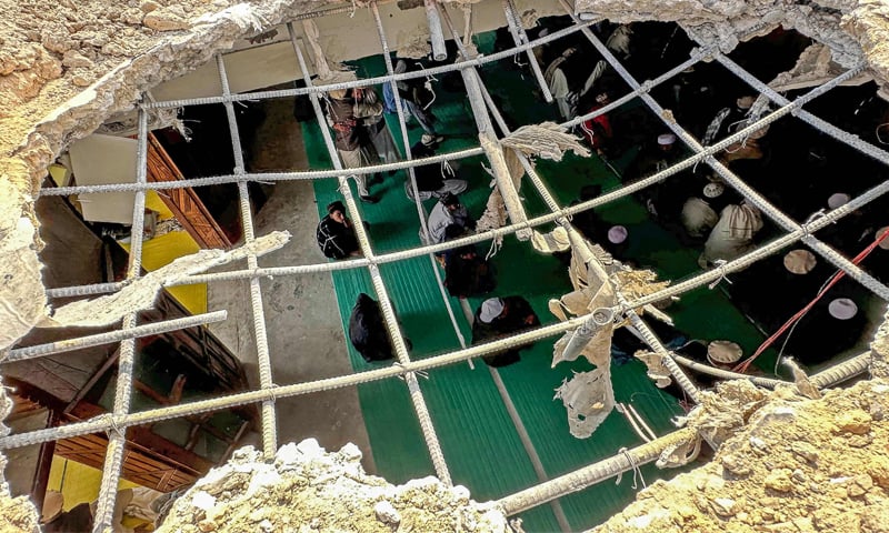 BAJAUR: Residents gather to offer Friday prayers inside a mosque damaged during overnight cross-border fighting between Pakistan and Afghanistan.&mdash;AFP